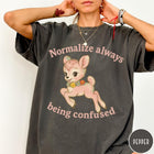 Comfort Colors tee in Pepper featuring vintage style fawn graphic with flowers and Normalize Always Being Confused text
