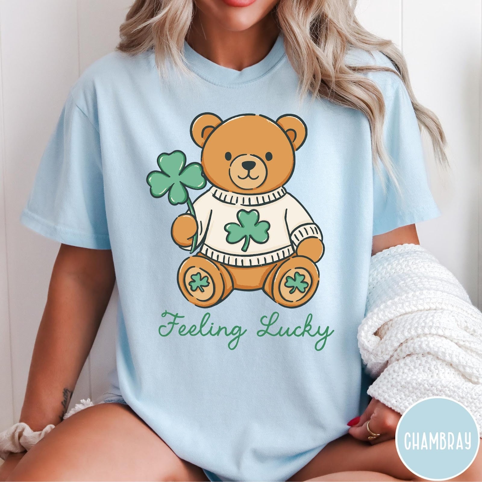 Comfort Colors tee in Chambray featuring illustrated teddy bear wearing a sweater and holding a four-leaf clover