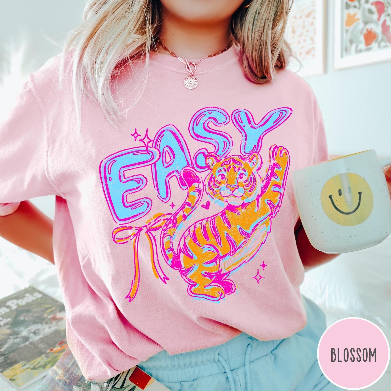 Comfort Colors tee in Blossom featuring retro style graphic of a tiger with blue and orange colors