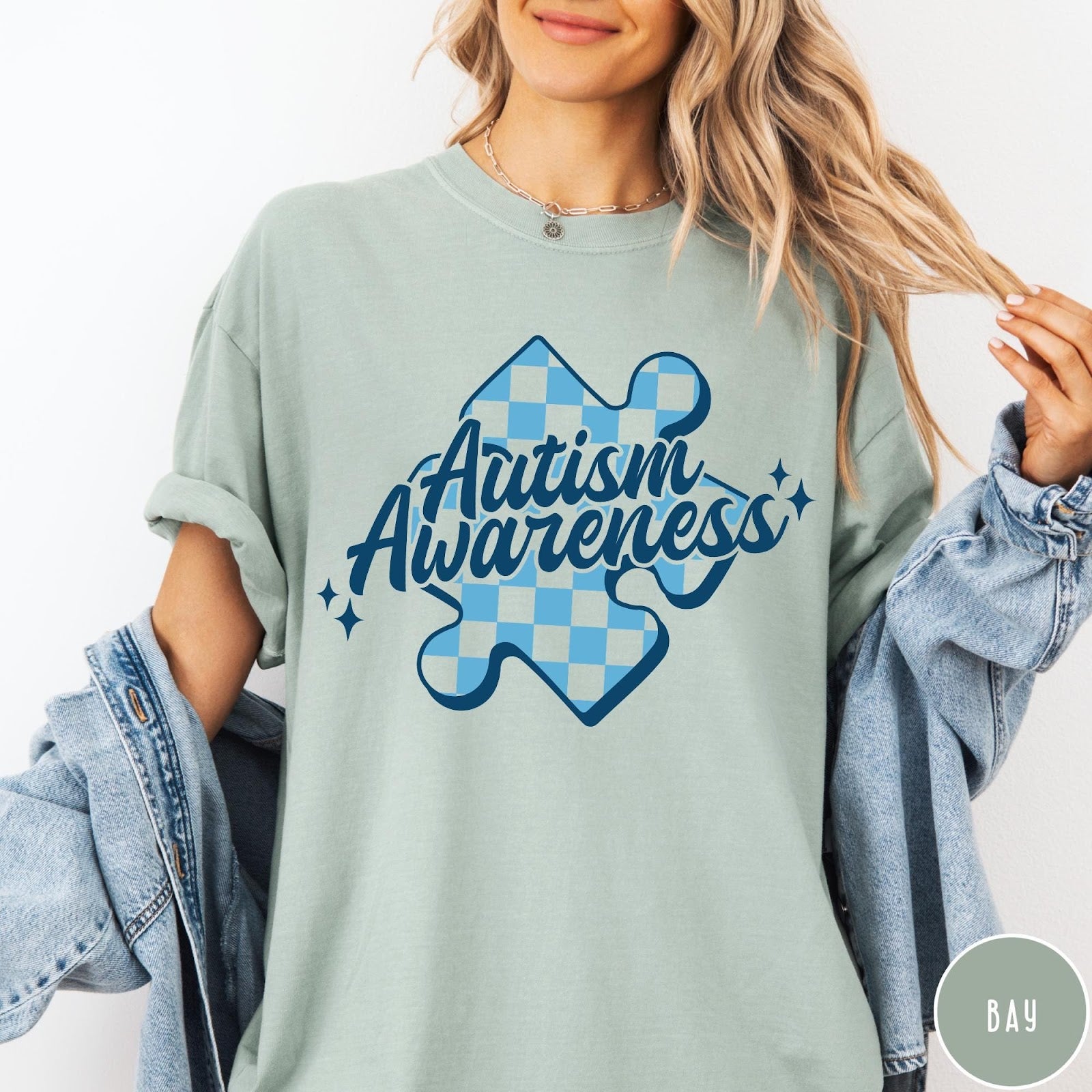 Comfort Colors tee in Bay featuring screen print style Autism Awareness puzzle piece with blue checkerboard pattern