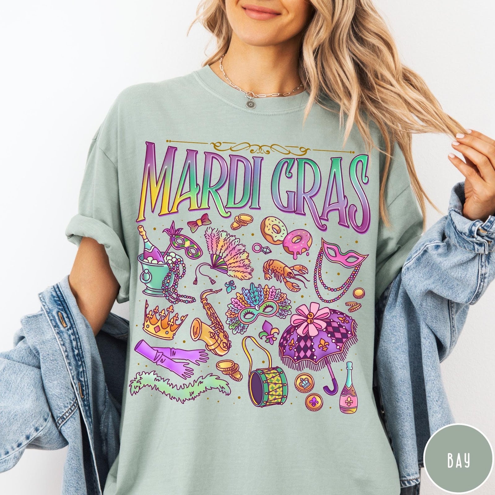 Comfort Colors tee in Bay featuring vintage style Mardi Gras celebration icons including masks, beads, and saxophone