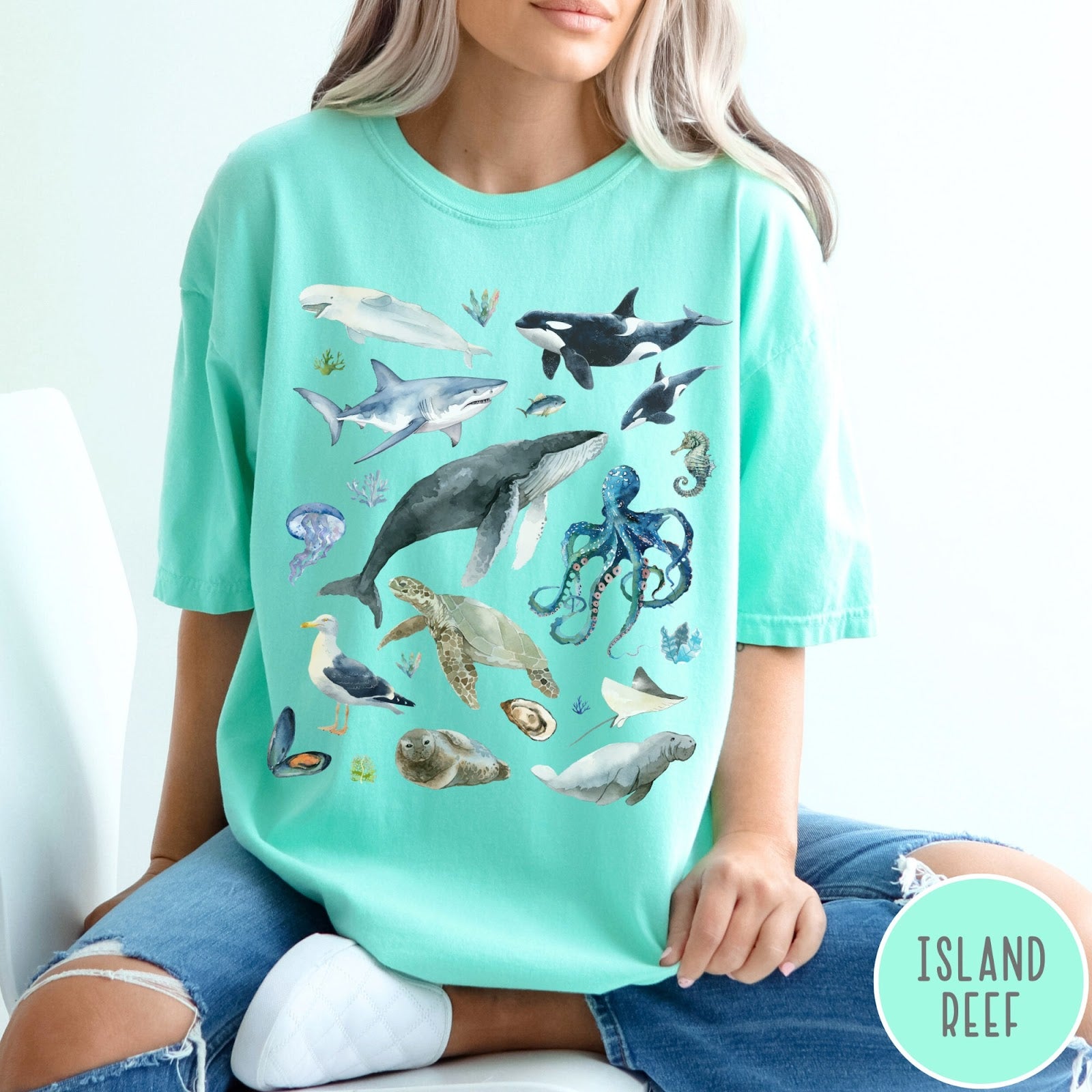 Comfort Colors tee in Island Reef featuring watercolor style graphic of various ocean animals including whales and sharks