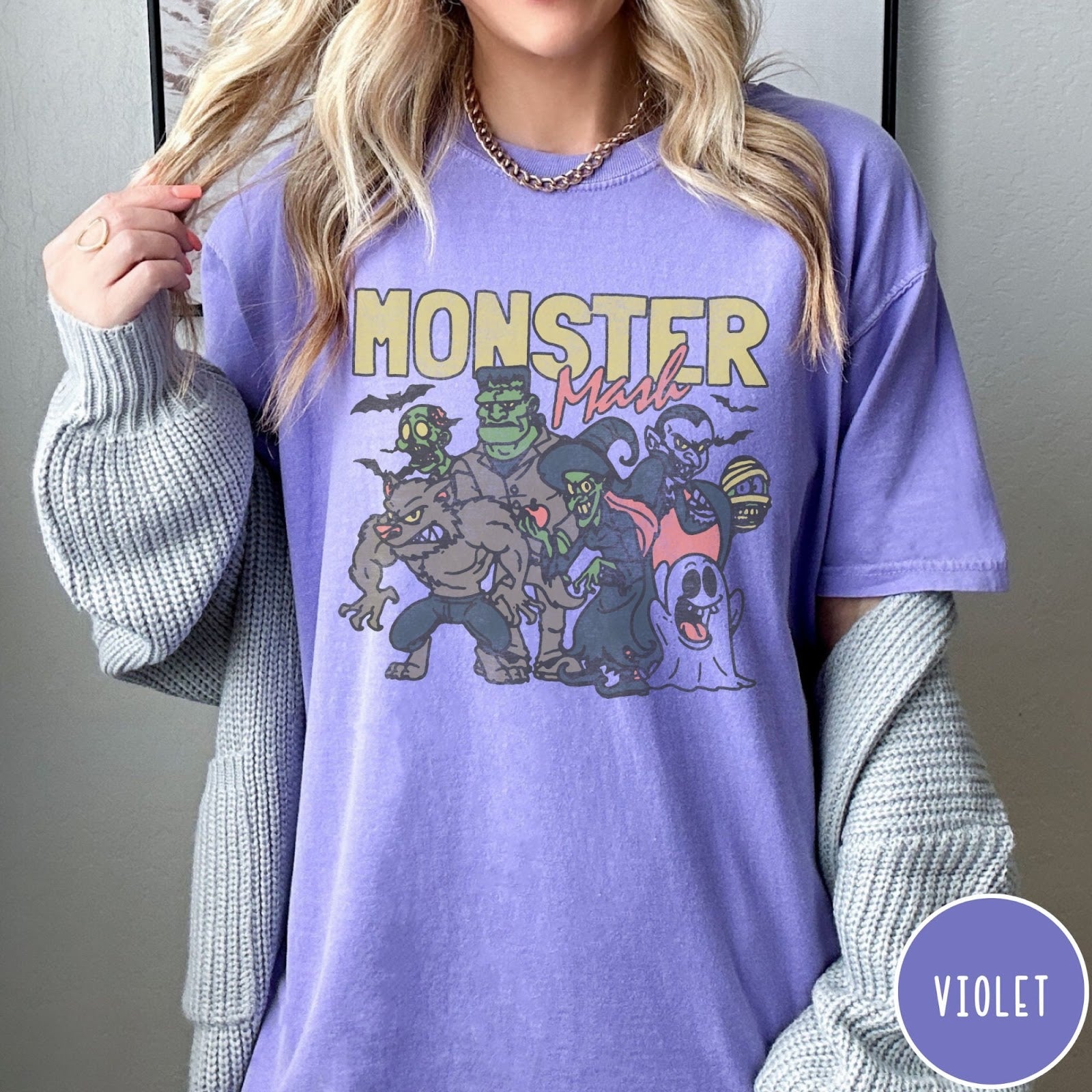 Comfort Colors tee in Violet featuring retro Halloween style graphic with various classic monsters and spooky characters