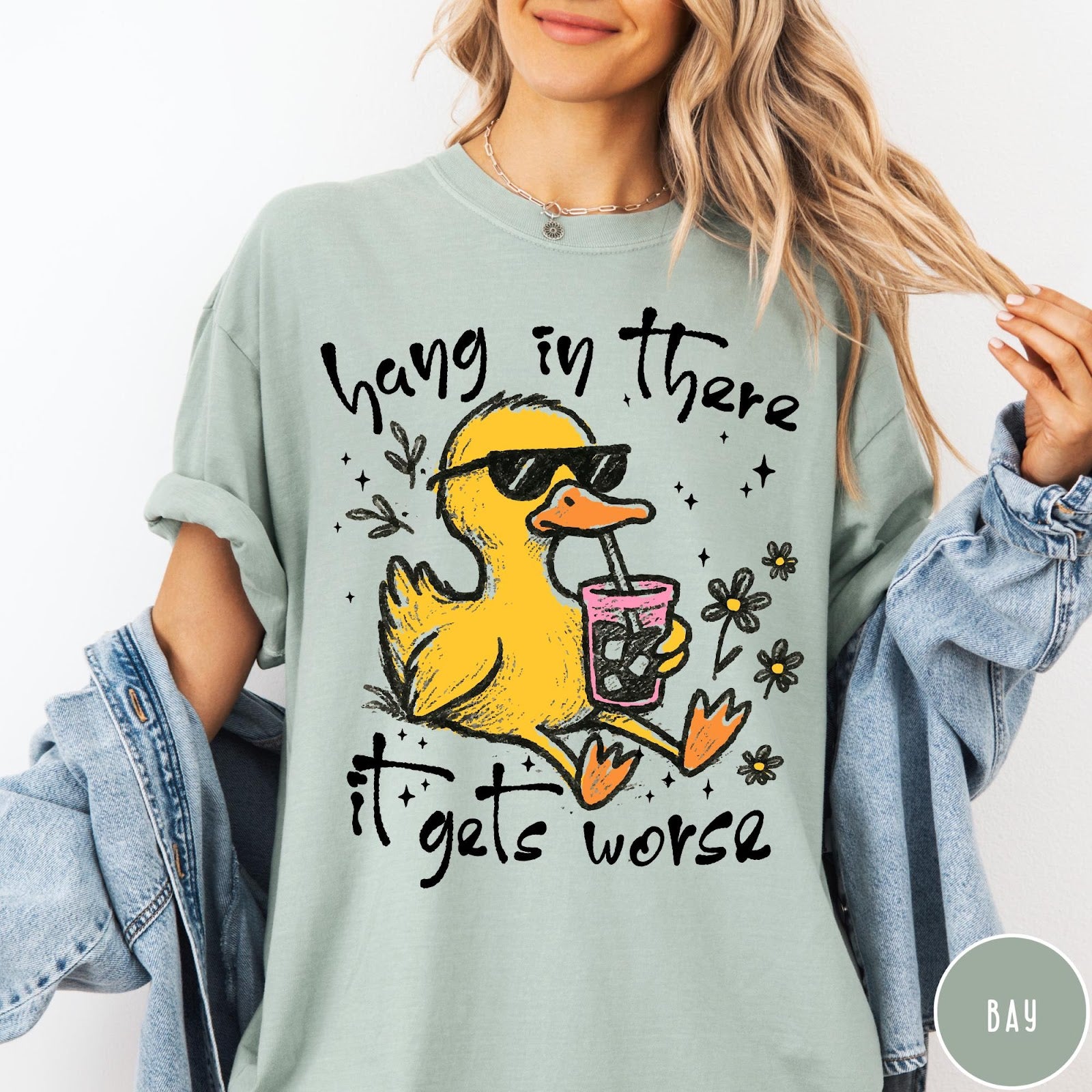 Comfort Colors tee in Bay featuring illustrated duck wearing sunglasses and drinking iced coffee with floral accents