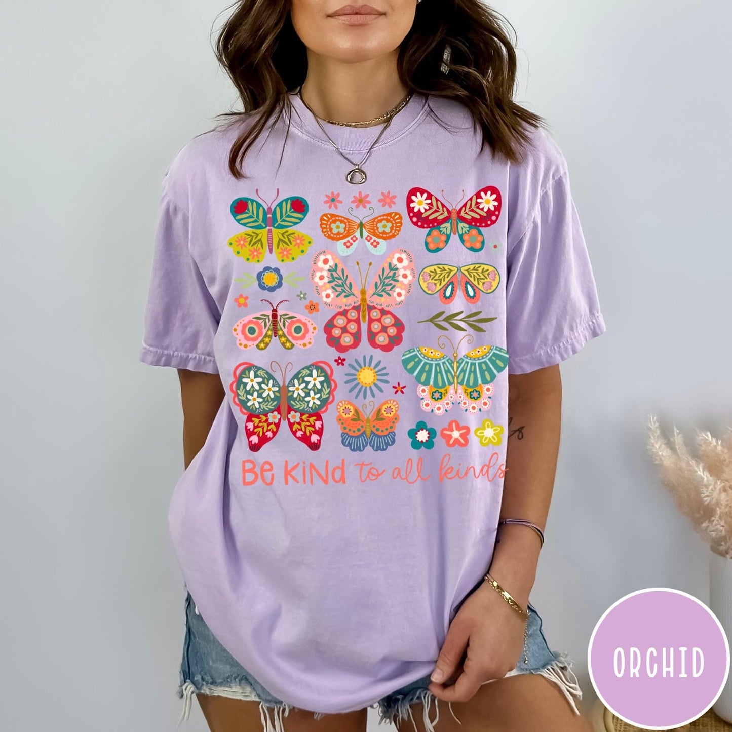 Comfort Colors tee in Orchid featuring butterfly and floral graphic design with Be Kind to all kinds text