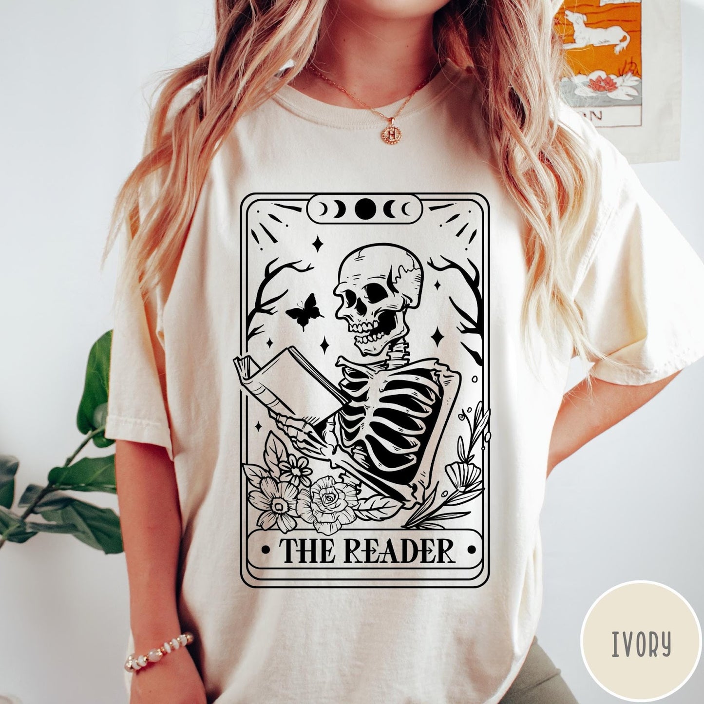 Comfort Colors tee in Ivory featuring tarot card style graphic of a skeleton reading a book