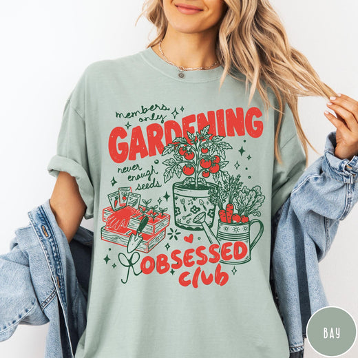 Comfort Colors tee in Bay featuring retro graphic gardening design with tomato plant, seeds, and gardening tools