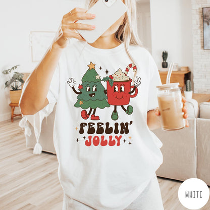 Comfort Colors tee in White featuring retro style graphic of a cartoon Christmas tree and cocoa mug