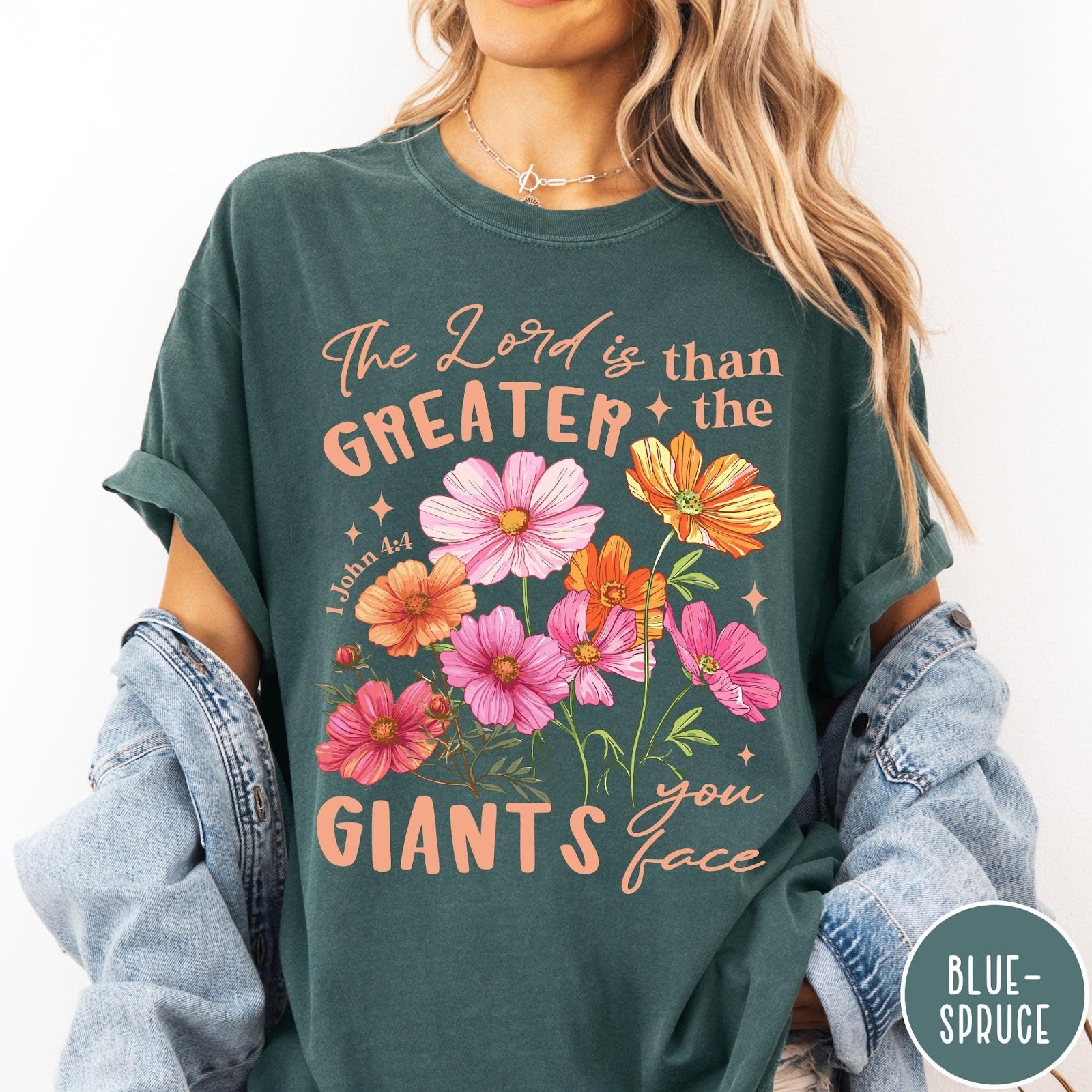 Comfort Colors tee in Blue Spruce featuring floral Bible verse graphic design with 1 John 4:4 scripture text