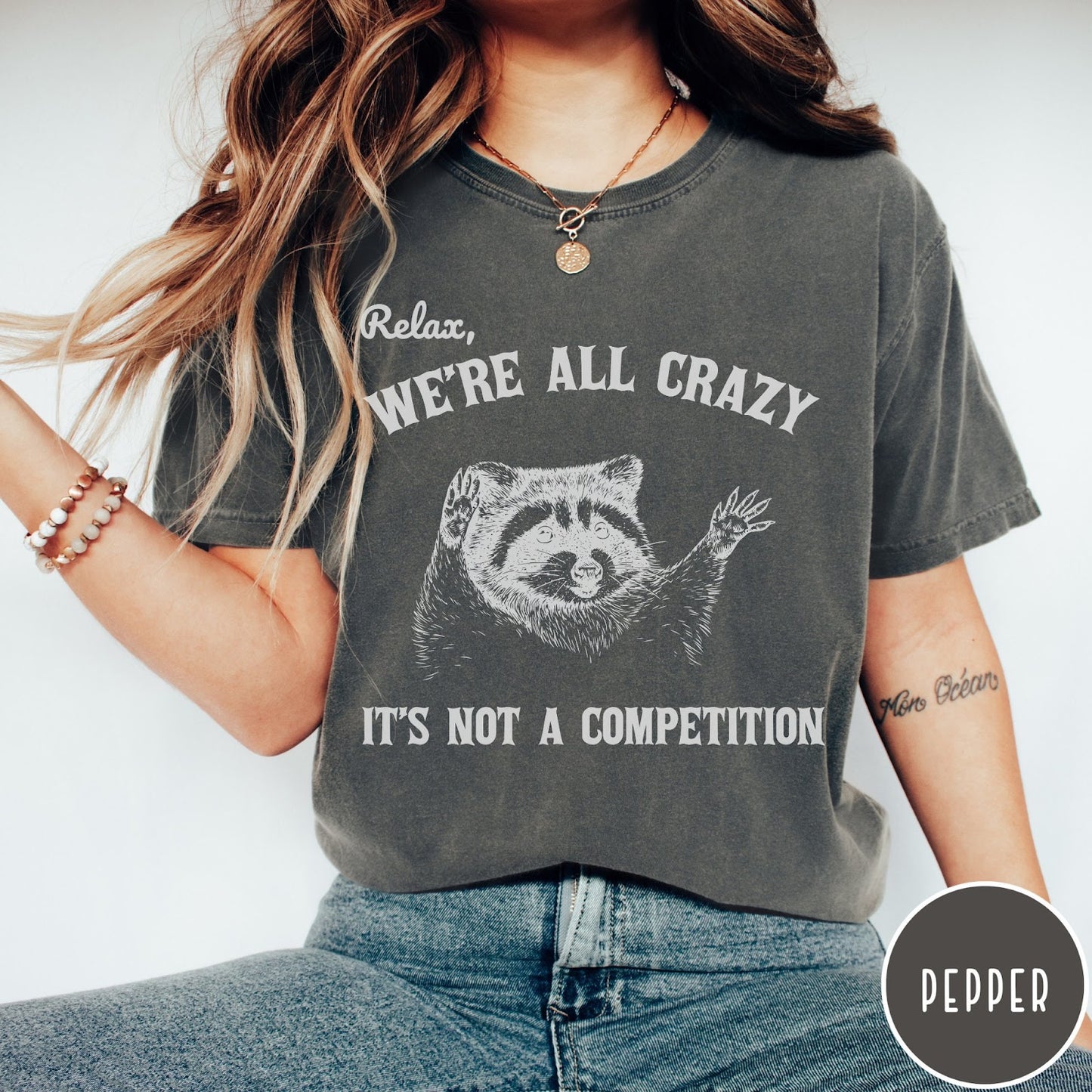 Comfort Colors tee in Pepper featuring screen print style graphic of a raccoon with text Relax We Are All Crazy