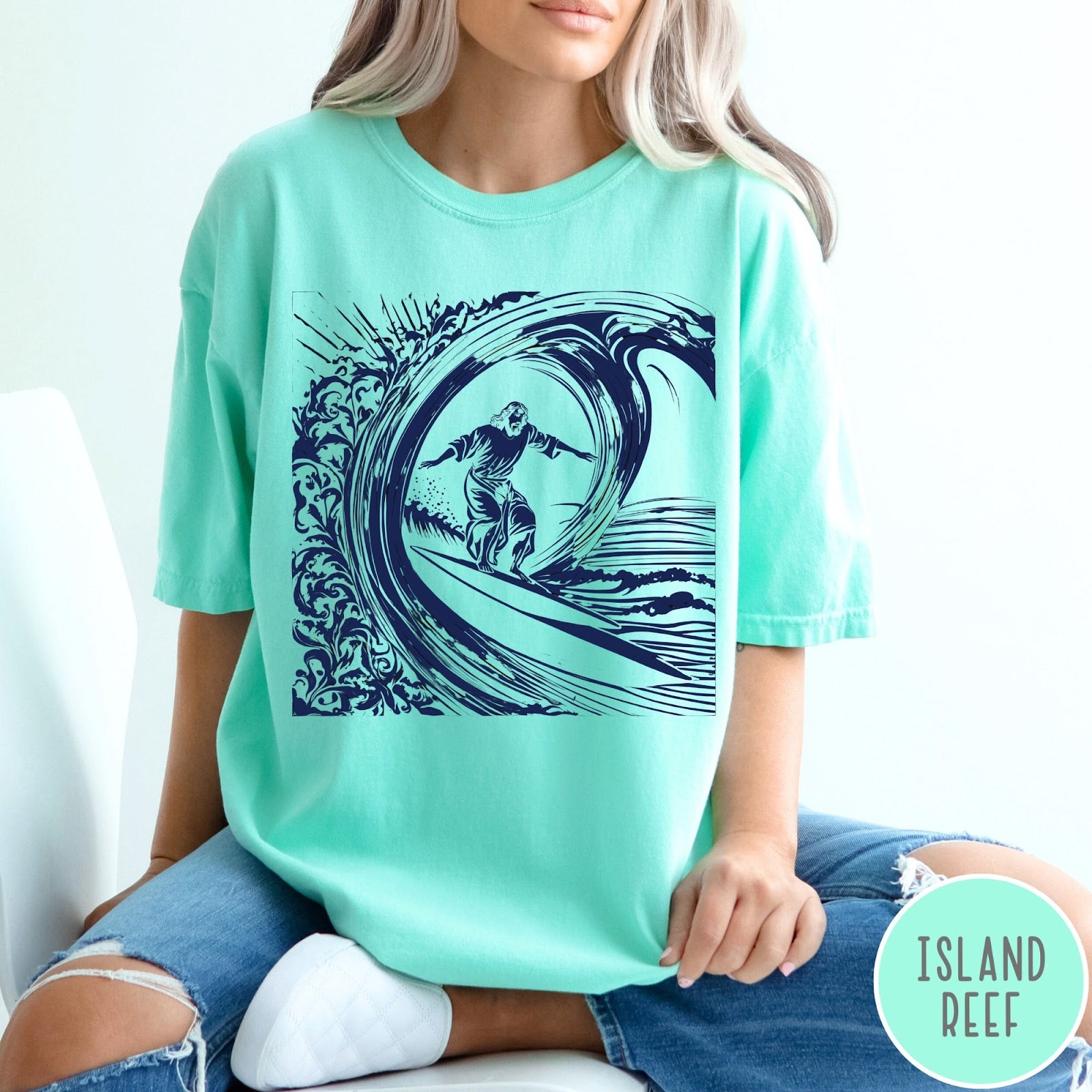 Comfort Colors tee in Island Reef featuring graphic style Jesus surfing on a large ocean wave
