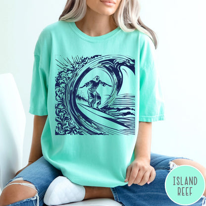 Comfort Colors tee in Island Reef featuring graphic style Jesus surfing on a large ocean wave
