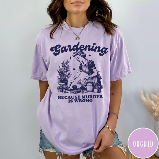 Comfort Colors tee in Orchid featuring vintage style graphic of a woman gardening with text about murder.