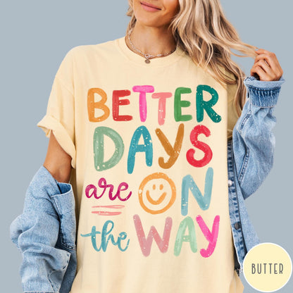 Comfort Colors tee in Butter featuring optimistic typography with Better Days Are On The Way graphic text