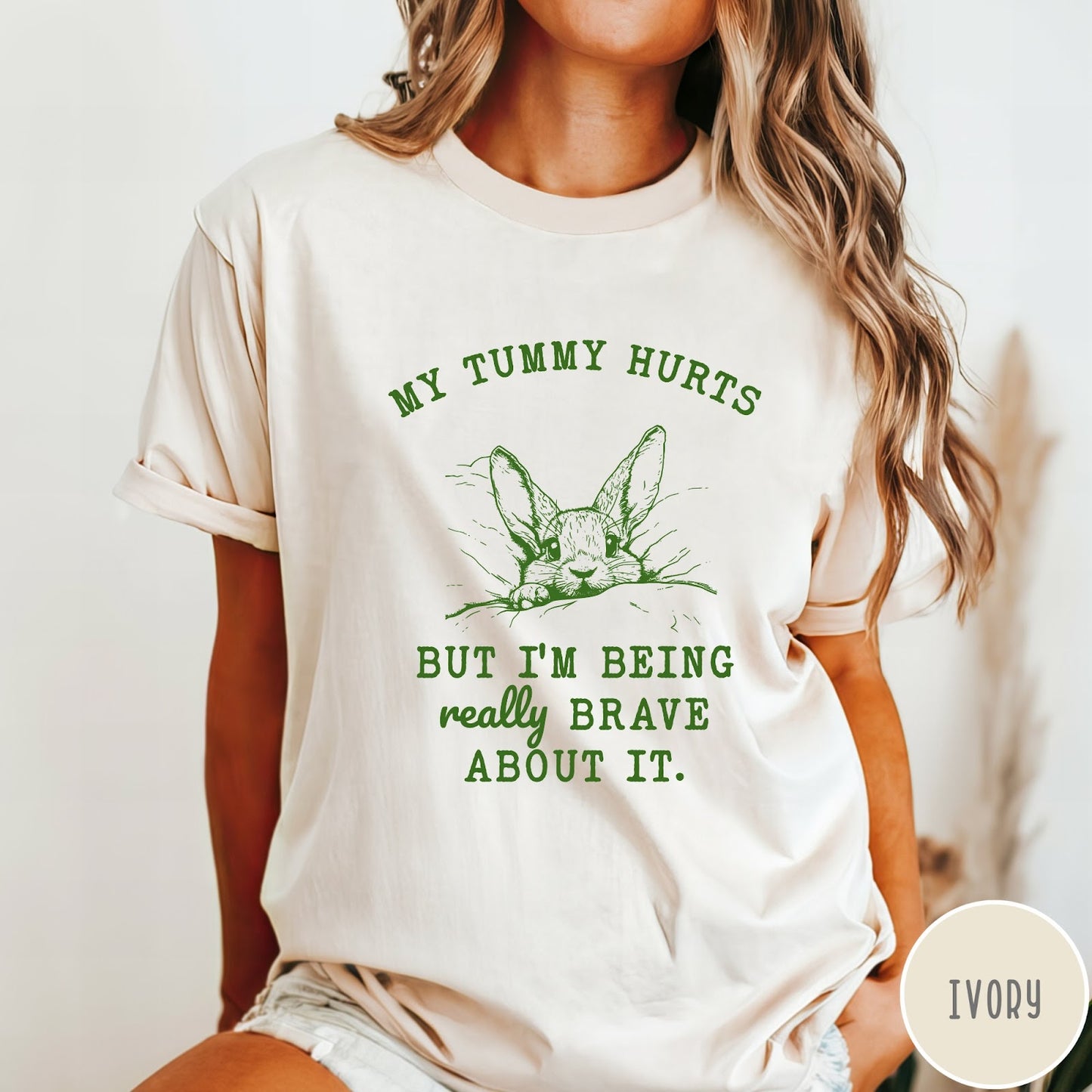 Comfort Colors tee in Ivory featuring line art graphic of a bunny with text My Tummy Hurts