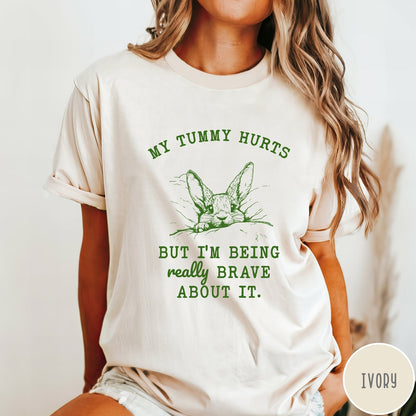 Comfort Colors tee in Ivory featuring line art graphic of a bunny with text My Tummy Hurts