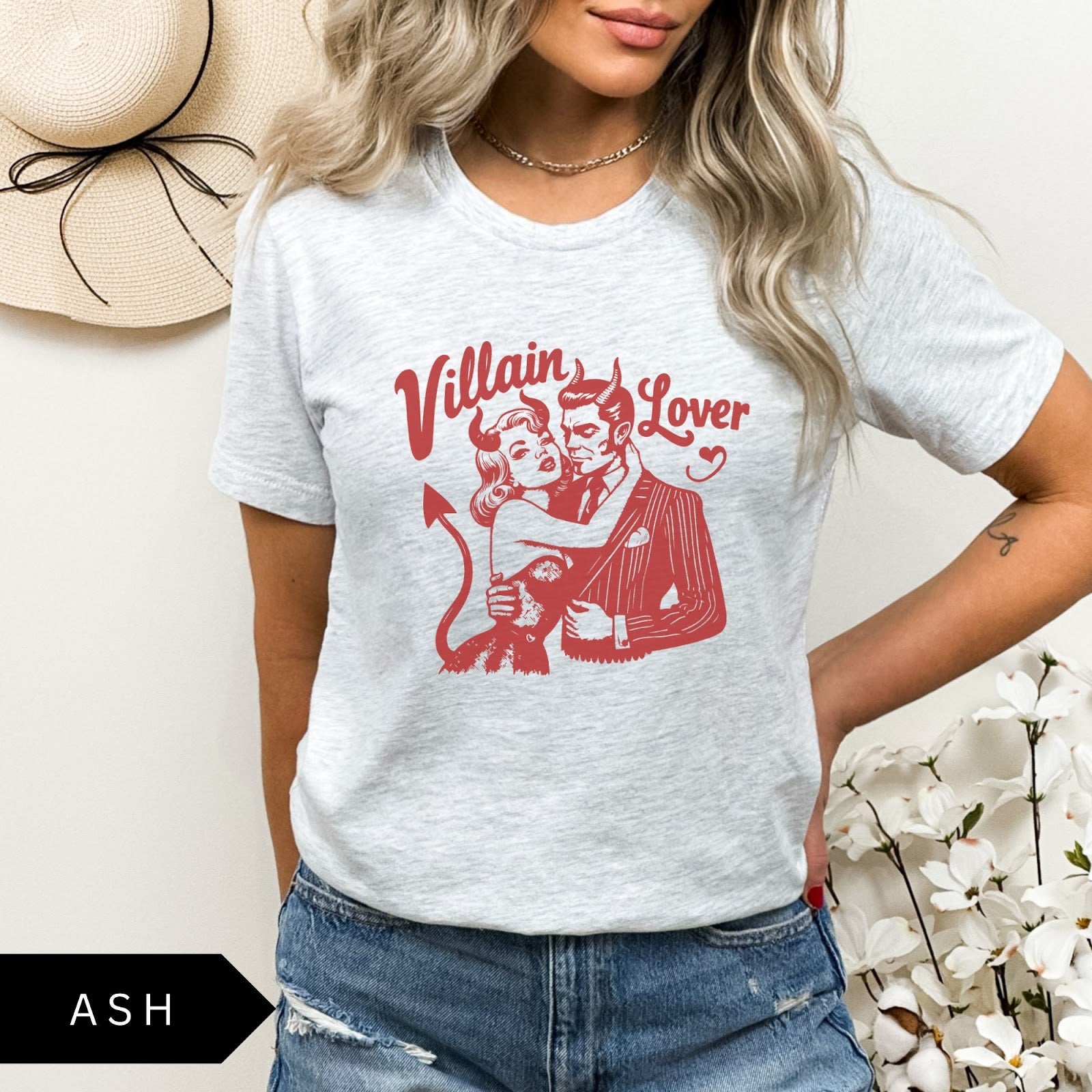 Comfort Colors tee in Ash featuring vintage style graphic of a devilish couple embracing with text Villain Lover