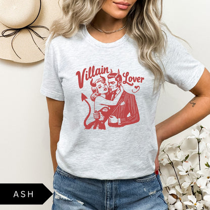 Comfort Colors tee in Ash featuring vintage style graphic of a devilish couple embracing with text Villain Lover