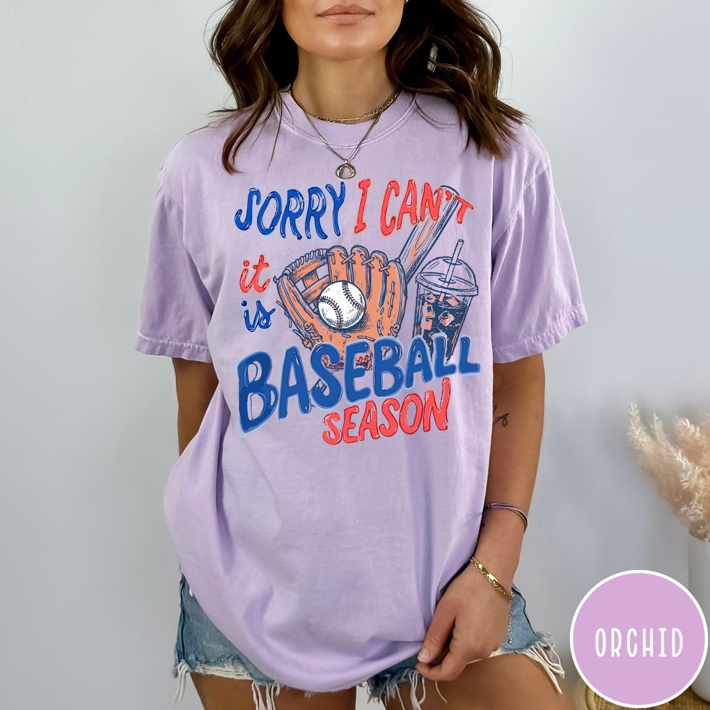 Comfort Colors tee in Orchid featuring baseball style graphic with glove, ball, bat, and iced coffee drink