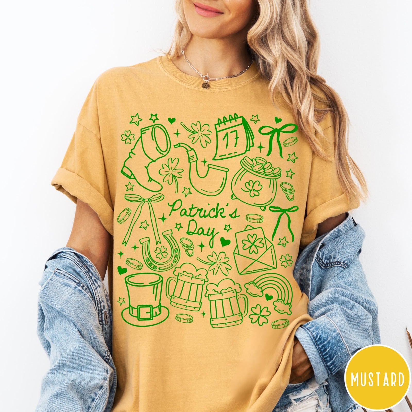 Comfort Colors tee in Mustard featuring line art style St. Patrick's Day icons including shamrocks and leprechaun hat