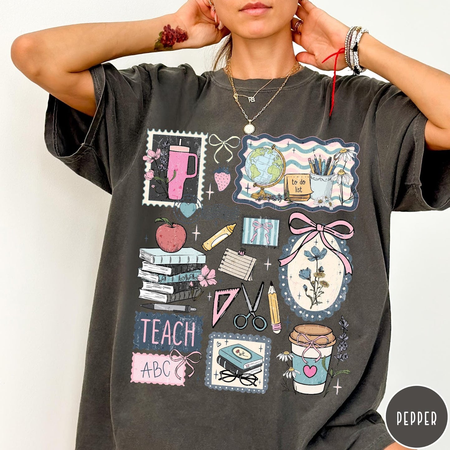 Comfort Colors tee in Pepper featuring collage style graphic with school supplies and teacher life themed illustrations