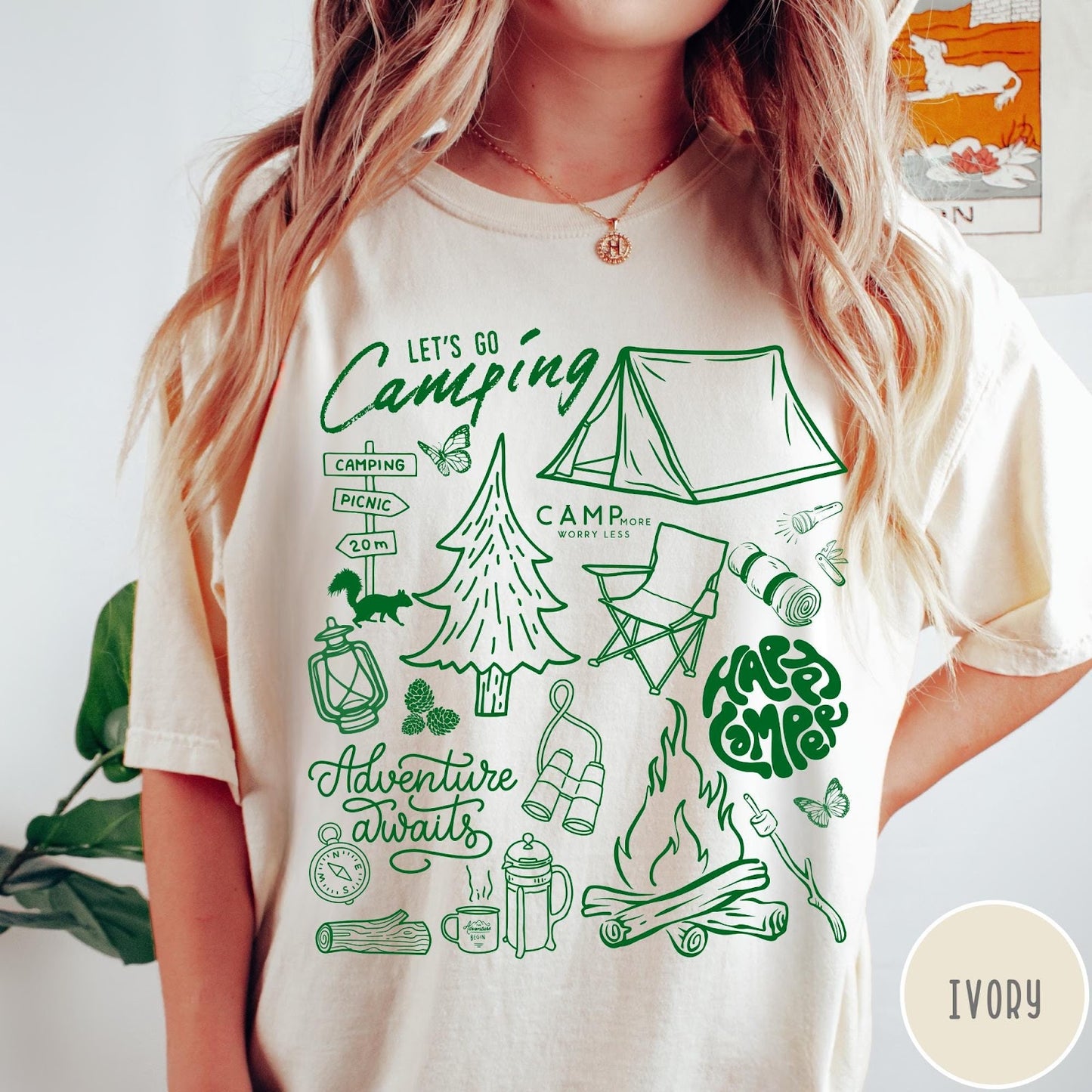 Comfort Colors tee in Ivory featuring retro camping adventure collage graphic with tent, campfire, and outdoor icons