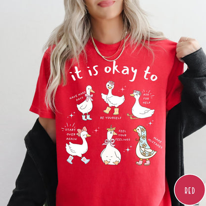 Comfort Colors tee in Red featuring cute cartoon geese with encouraging text about mental health and self-care