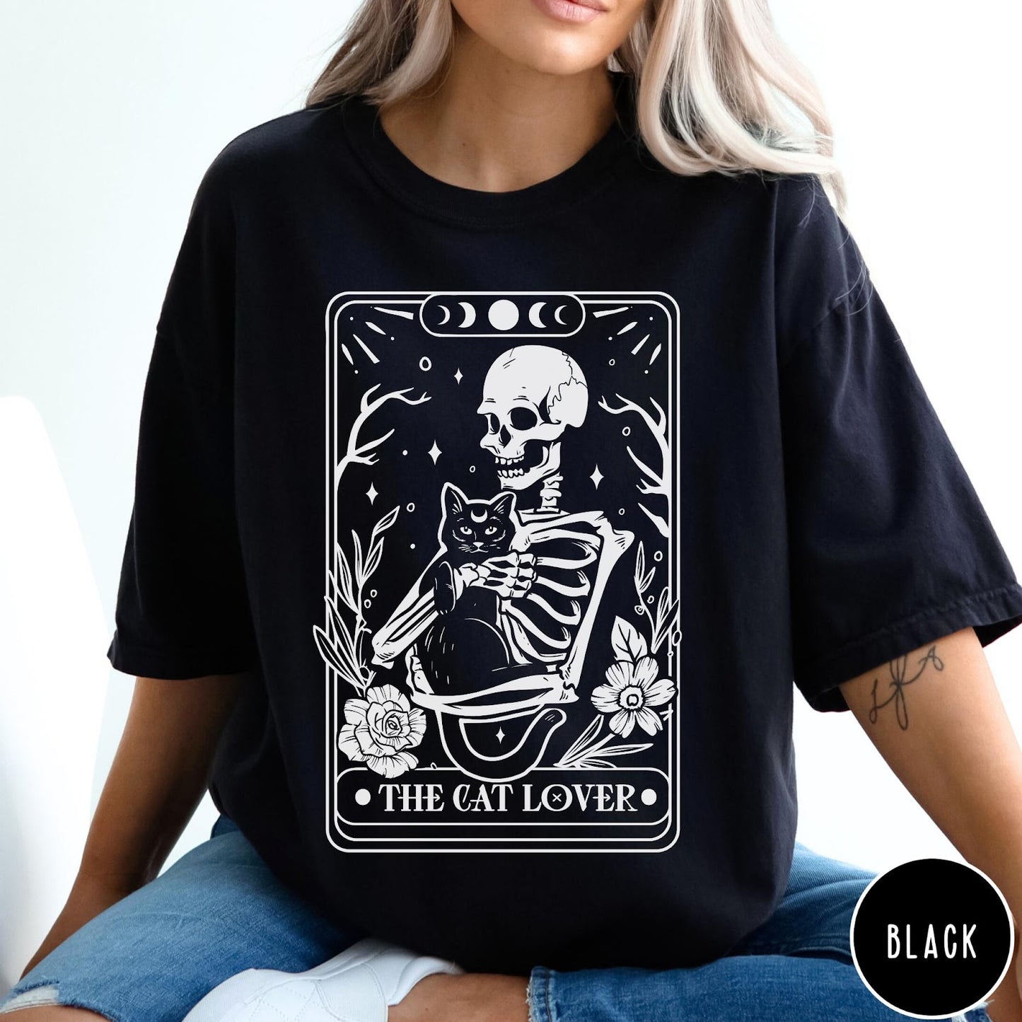 Comfort Colors tee in Black featuring tarot style graphic of a skeleton holding a black cat