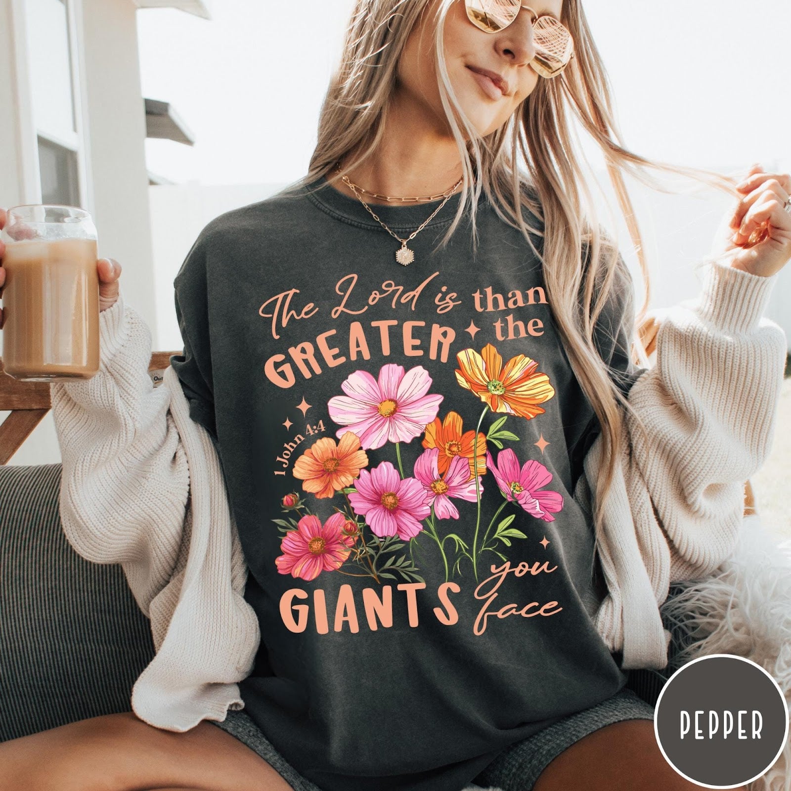 Comfort Colors tee in Pepper featuring floral graphic design with Bible verse The Lord is Greater text