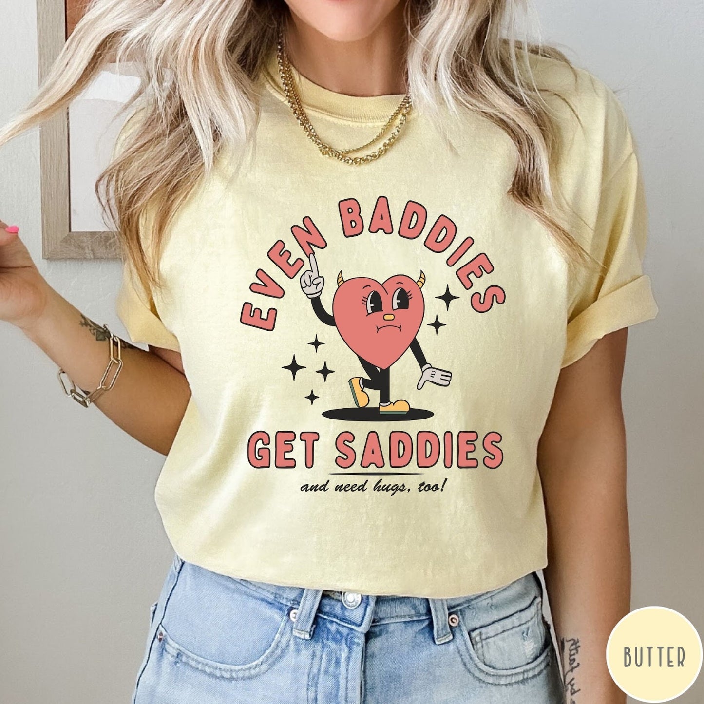 Comfort Colors tee in Butter featuring retro style graphic of a sad heart character with devil horns