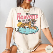 Comfort Colors tee in Ivory featuring retro graphic design of a roaring tiger resting on a cloud