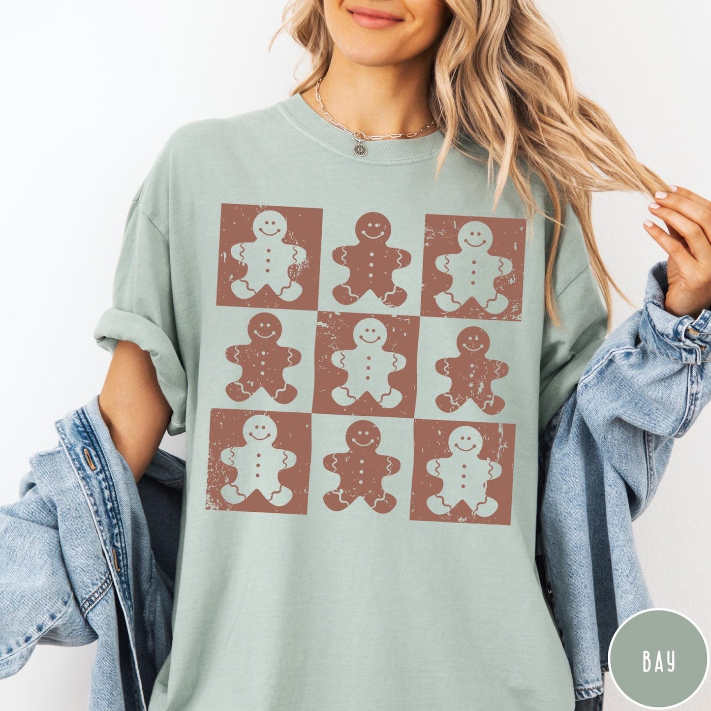 Comfort Colors tee in Bay featuring a grid design with distressed brown and white gingerbread cookie graphic prints