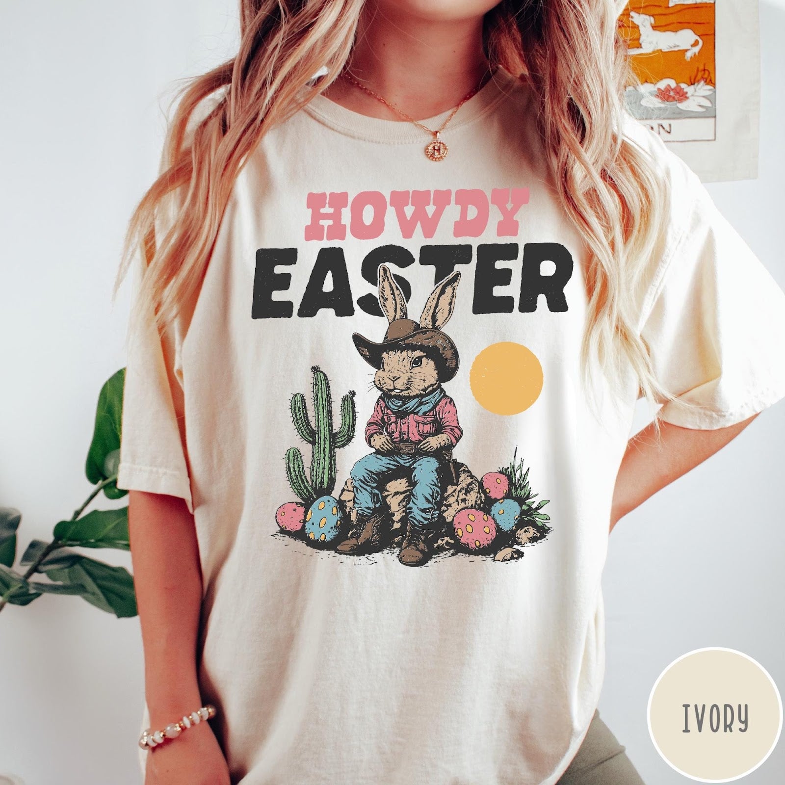 Comfort Colors tee in Ivory featuring western design style cowboy bunny sitting on a rock with cactus