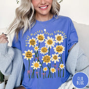 Comfort Colors tee in Flo Blue featuring daisy graphic with positive affirmations and encouraging words about kindness