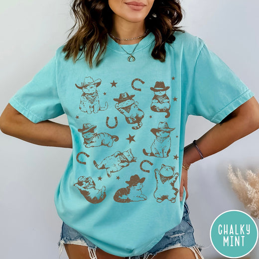 Comfort Colors tee in Chalky Mint featuring western graphic style with multiple cowboy kittens and horseshoe illustrations