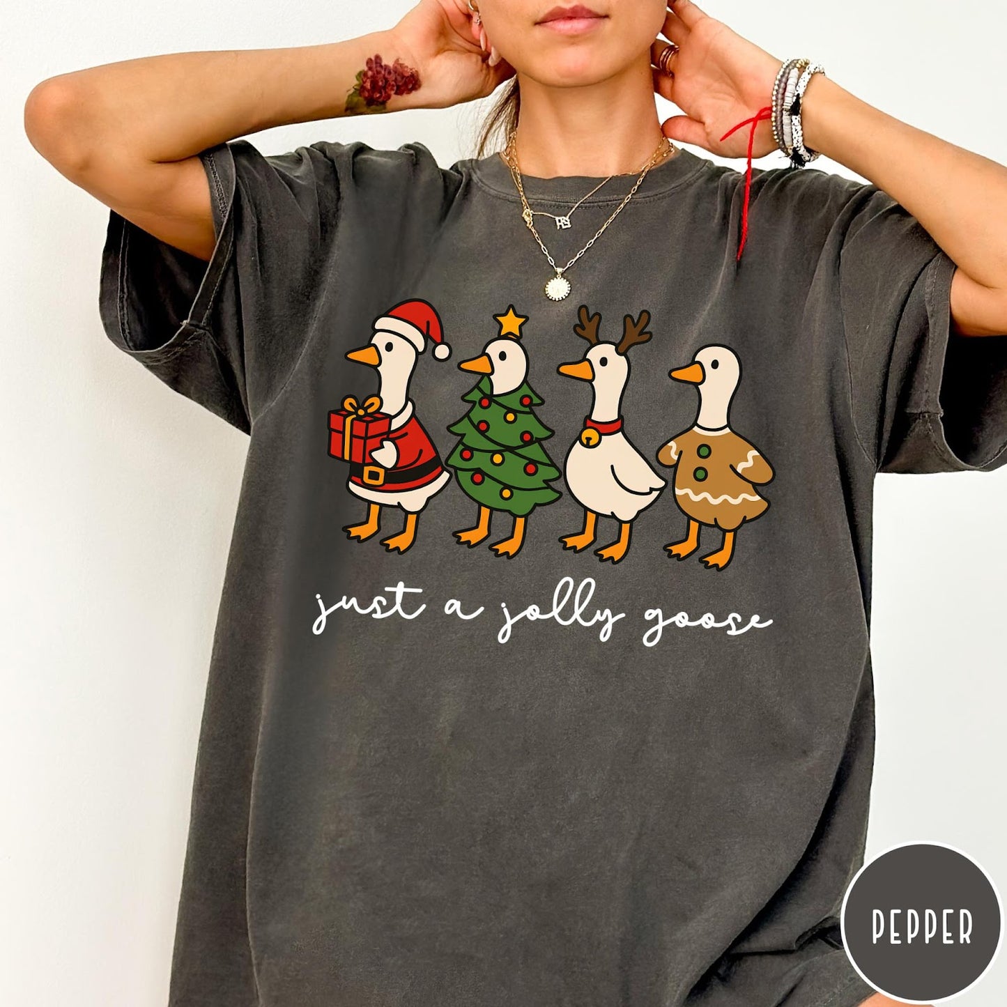 Comfort Colors tee in Pepper featuring festive geese graphic with Santa, Christmas tree, reindeer, and gingerbread goose designs