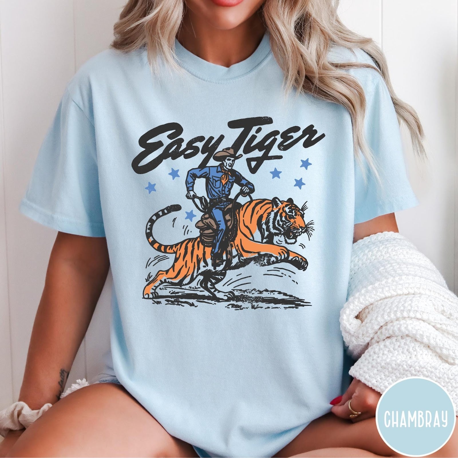 Comfort Colors tee in Chambray featuring western graphic style cowboy riding a tiger with blue stars