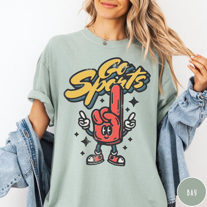 Comfort Colors tee in Bay featuring retro mascot design with a red foam finger character and text