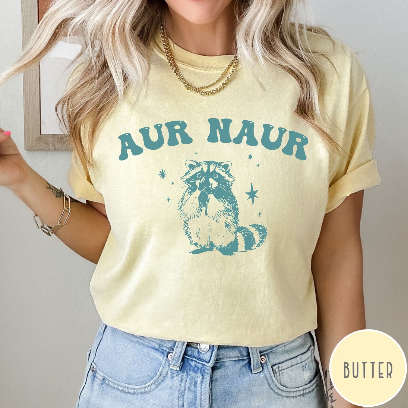 Comfort Colors tee in Butter featuring retro style graphic of a raccoon with stars and text