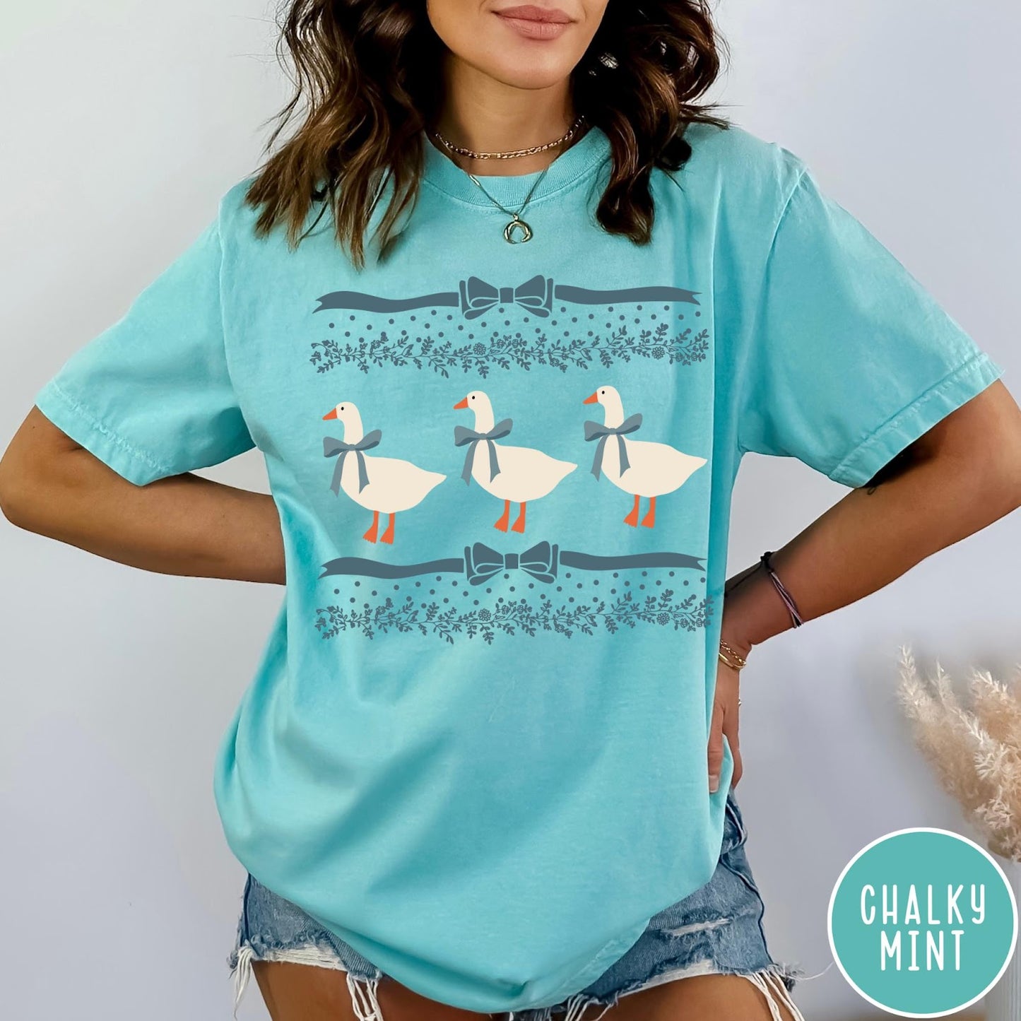 Comfort Colors tee in Chalky Mint featuring vintage style graphic with three geese wearing blue ribbons and floral borders