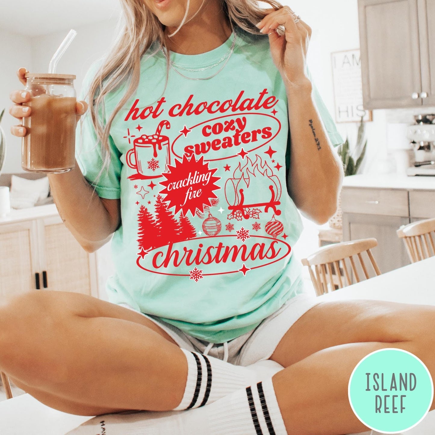 Comfort Colors tee in Island Reef featuring holiday graphic design with hot chocolate, fire, and Christmas trees