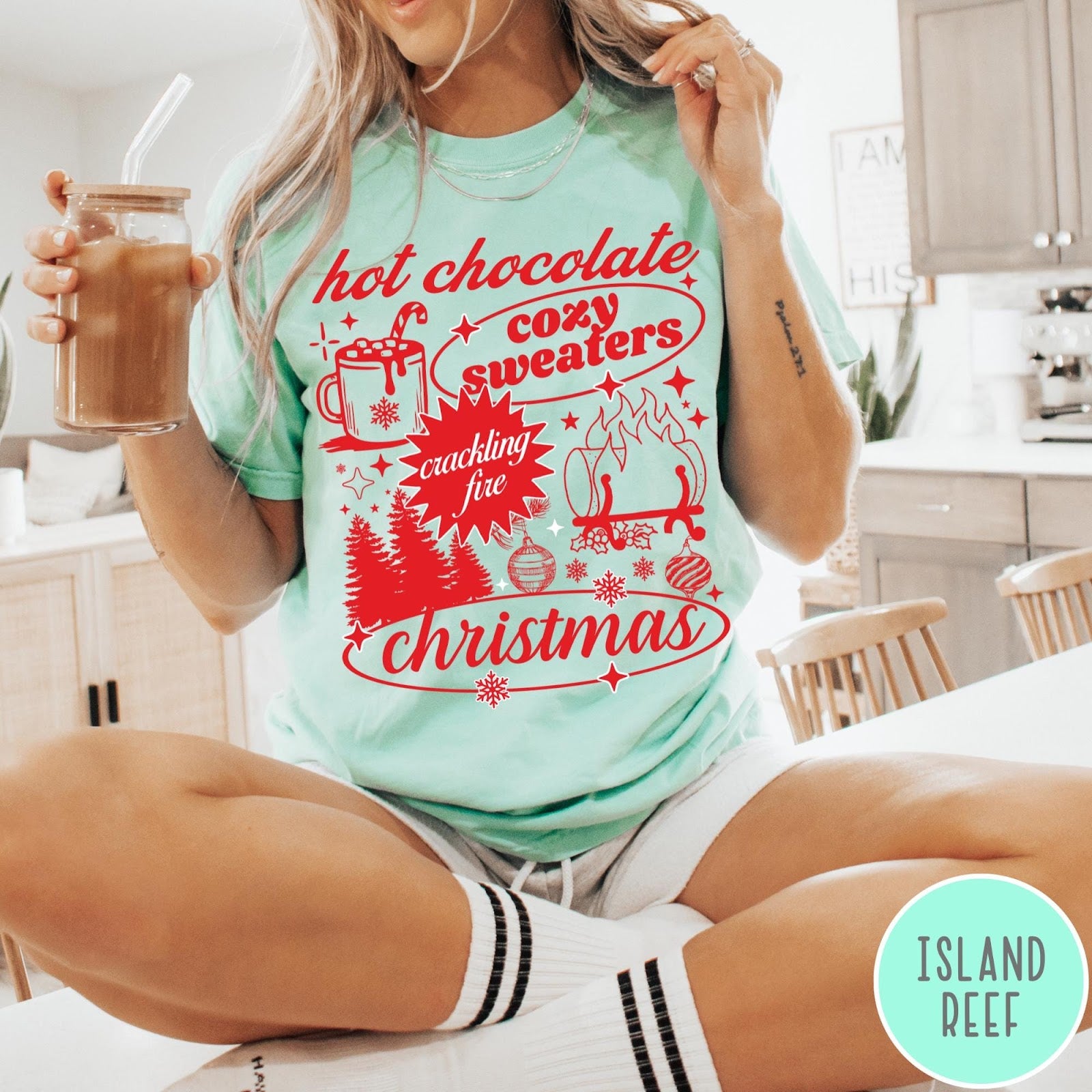 Comfort Colors tee in Island Reef featuring holiday graphic design with hot chocolate, fire, and Christmas trees