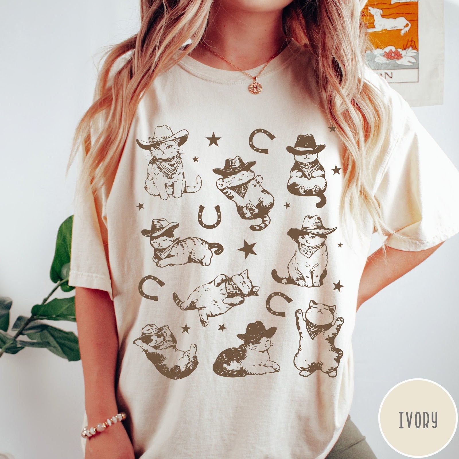 Comfort Colors tee in Ivory featuring western graphic style with multiple cowboy kittens and horseshoe illustrations