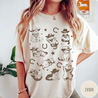 Comfort Colors tee in Ivory featuring western graphic style with multiple cowboy kittens and horseshoe illustrations