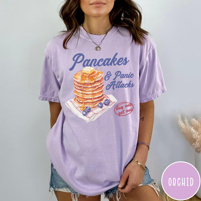 Comfort Colors tee in Orchid featuring watercolor style graphic of a stack of pancakes with blueberries and syrup