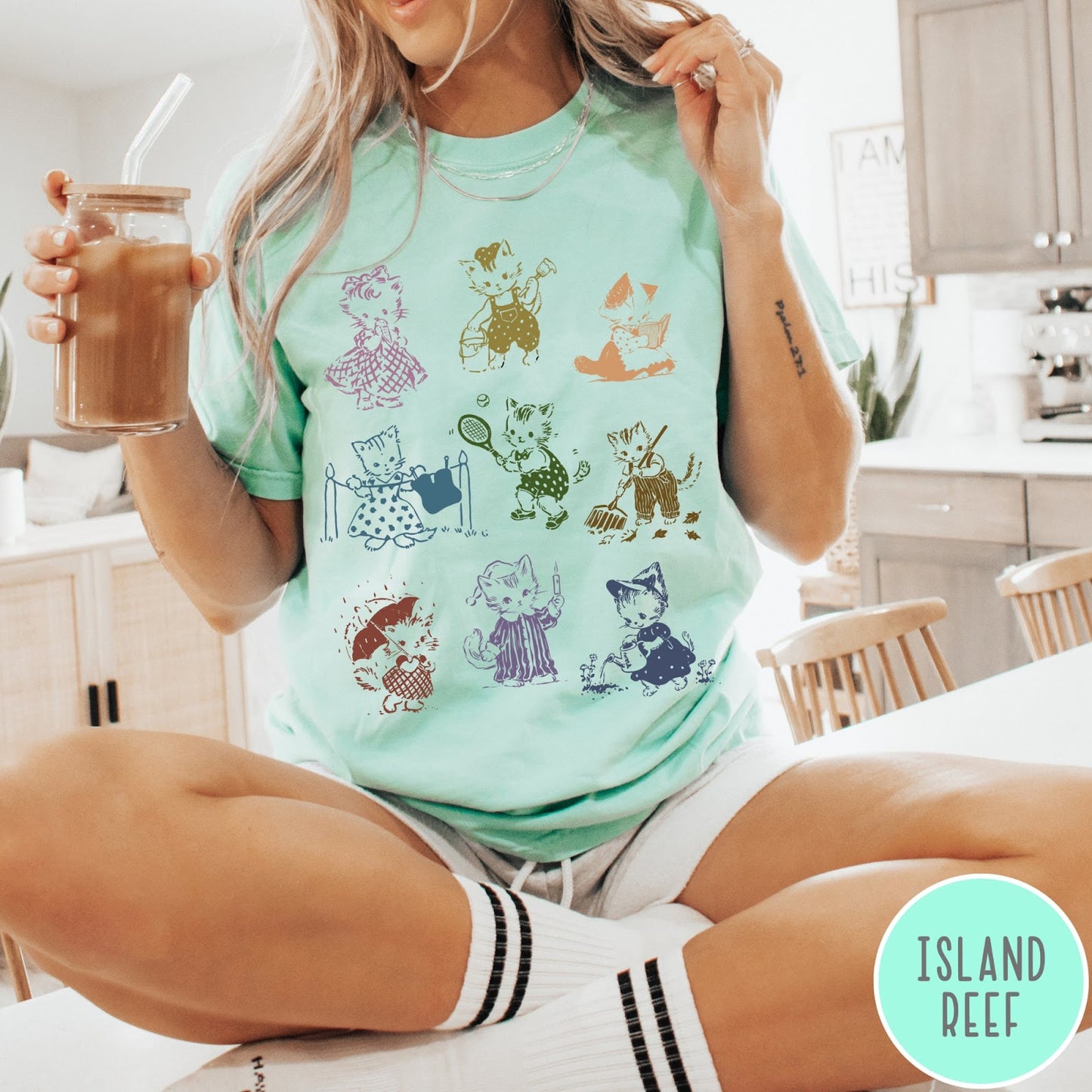 Comfort Colors tee in Island Reef featuring vintage retro style graphic of nine kittens doing various daily activities