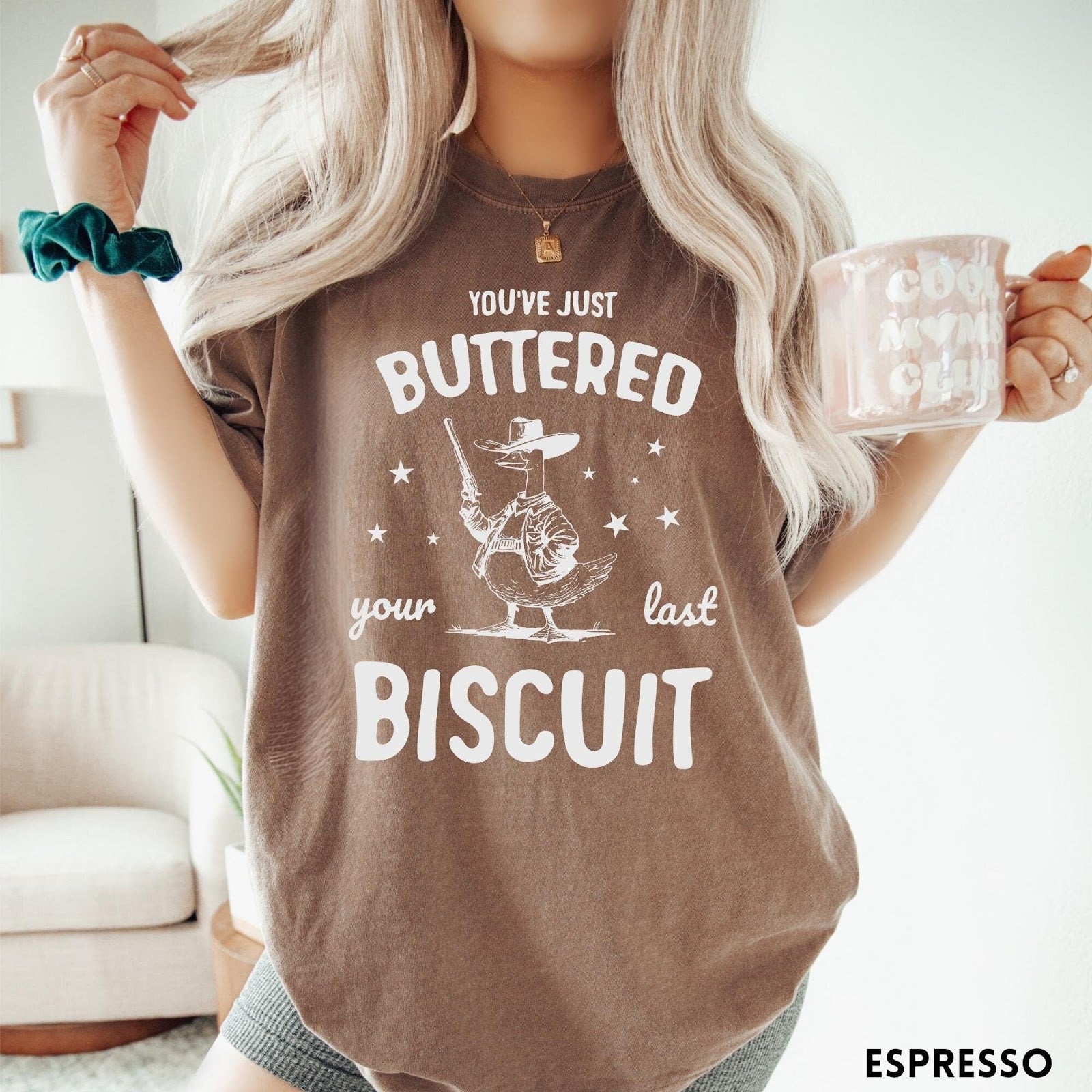 Comfort Colors tee in Espresso featuring western graphic style cowboy goose holding a revolver with star accents