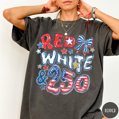 Comfort Colors tee in Pepper featuring patriotic 250th anniversary graphic with red white and blue stars and bow
