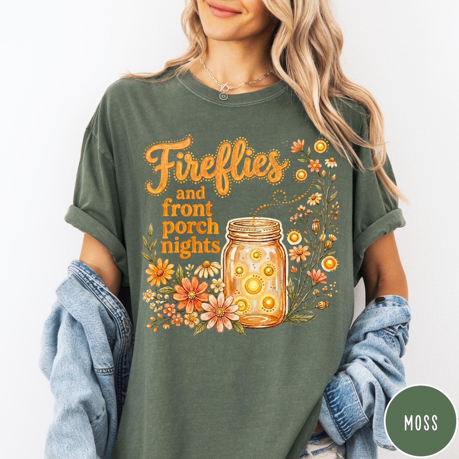 Comfort Colors tee in Moss featuring whimsical graphic design of fireflies in a mason jar with wildflowers