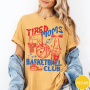 Comfort Colors tee in Mustard featuring basketball mom life graphic with basketball, hoop, whistle, and drink illustration